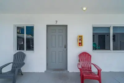 two chairs sitting outside of a house with a door at Lovely Studio Walking Distance To Ocean - Suite 7 in Hollywood