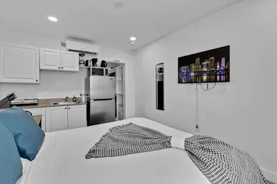 a kitchen with a bed with a tie on it at Lovely Studio Walking Distance To Ocean - Suite 7 in Hollywood