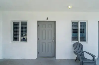 a door and a chair in front of a house at Lovely Studio Walking Distance To Ocean - Suite 8 in Hollywood