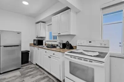 a kitchen with white appliances and white cabinets at Lovely 1 Bedroom Walking Distance To Ocean - Suite 9 in Hollywood