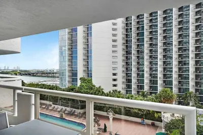 a balcony with a view of a large building at Calypso - Gorgeous Miami Renovated Spacious Condo! in Miami