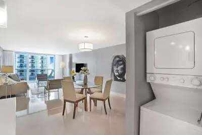 a kitchen and dining room with a table and chairs at SeaDuced By Miami Skyline And Bay Views! in Miami