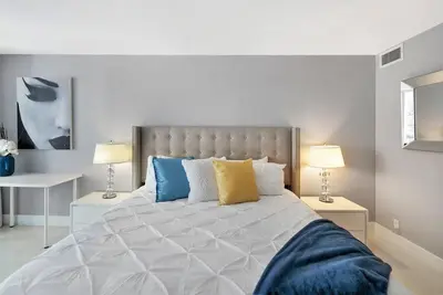 a bedroom with a large bed with two lamps at SeaDuced By Miami Skyline And Bay Views! in Miami