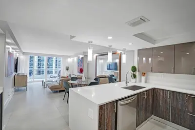 a kitchen with a counter and a living room at Electric Love Brand New With Water View, Edgewater in Miami