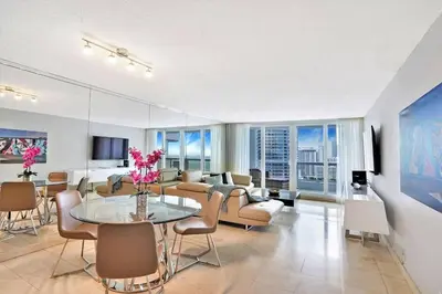 a living room with a couch and a table and chairs at Endless Summer! Incredible Water Views in Miami