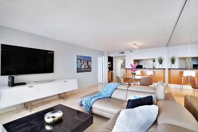 a living room with a couch and a flat screen tv at Endless Summer! Incredible Water Views in Miami