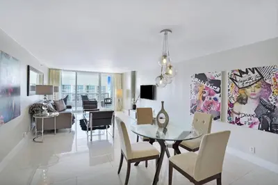 a dining room and living room with a table and chairs at Dreamscape! Renovated and spacious 1 bedroom condo in Miami