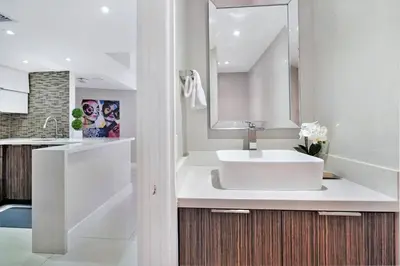 a white bathroom with a sink and a mirror at Dreamscape! Renovated and spacious 1 bedroom condo in Miami