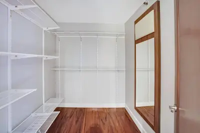a walk in closet with a mirror and a door at Wait N' Sea! Direct Water Views, Steps From Pool! in Miami