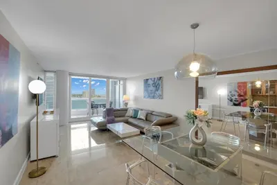 a living room with a couch and a glass table at Permanent Vacation! Direct Water Views! in Miami