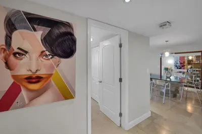 a painting of a woman on the wall of a room at Permanent Vacation! Direct Water Views! in Miami