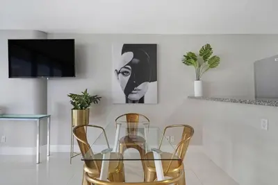 a dining room with a glass table and two chairs at Dance with me! Water and Park Views! in Miami