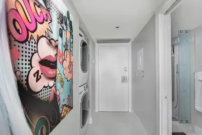 a bathroom with a painting of a face on the wall at Dance with me! Water and Park Views! in Miami