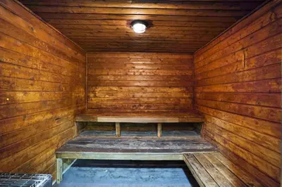 an empty wooden sauna with a bench in it at A Wave From It All! Direct water views! in Miami