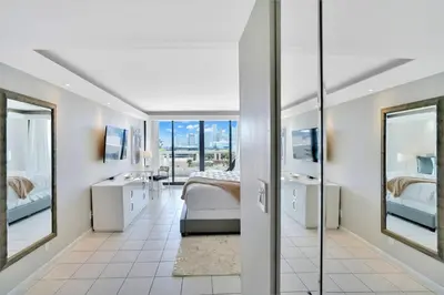 a bedroom with two beds and two mirrors at Sea Forever! Miami Skyline And Water Views in Miami