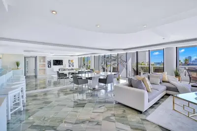 a living room with couches and tables and windows at Sea Forever! Miami Skyline And Water Views in Miami