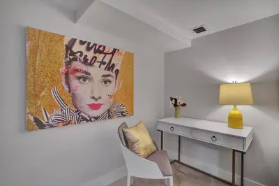 a room with a desk and a painting on the wall at GoldDust - Water and City Views! in Miami