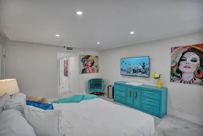 a bedroom with a bed and a blue dresser at GoldDust - Water and City Views! in Miami