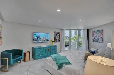 a bedroom with a large bed and a blue cabinet at GoldDust - Water and City Views! in Miami