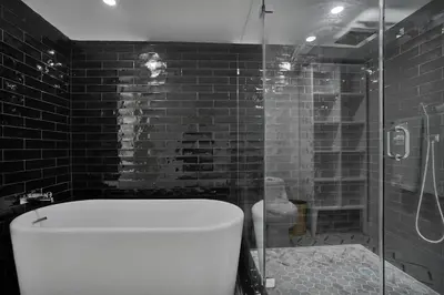 a bathroom with a toilet and a glass shower at GoldDust - Water and City Views! in Miami