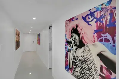 a painting of a woman on a wall in a hallway at Walking on Water! Water Views! in Miami