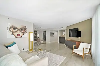 a living room with a couch and a tv at Sun-Kissed & Sunshine! Direct Water and City Views in Miami