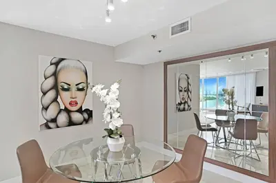 a dining room with a glass table and chairs at Sun-Kissed & Sunshine! Direct Water and City Views in Miami