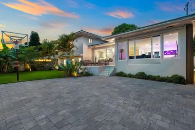 a house with a basketball hoop in the backyard at Beautiful Villa with heated pool Must seen! in Miami
