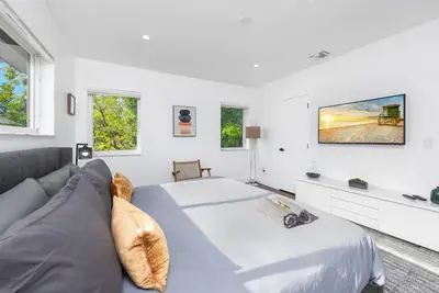 a white bedroom with a bed and a couch at Beautiful Villa with heated pool Must seen! in Miami