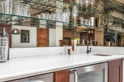 a kitchen with glass shelves and a counter with a sink at Villa sleeps 18 in Miami Shores with Movie theater / Pool / Jacuzzi in Miami