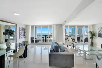 a living room with a couch and a glass table at Meet Me in Miami! Impressive Miami Skyline Views in Miami