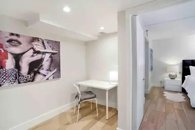 a white bedroom with a desk and a painting on the wall at Aqua Marina! Water & City Views! in Miami