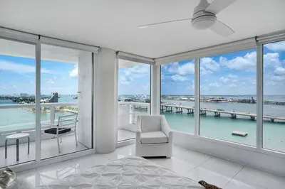 a bedroom with a bed and a view of the water at Seas The Day! Complete Panoramic Water Views in Miami