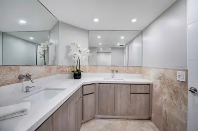 a bathroom with two sinks and two mirrors at First Class! - Crystal clear water views! in Miami