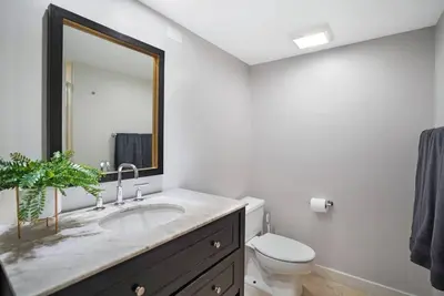 a bathroom with a sink and a toilet and a mirror at Good Morning Beautiful! Direct Water Views in Miami