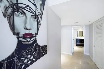 a painting of a woman on a wall next to a hallway at Good Morning Beautiful! Direct Water Views in Miami