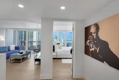 a white living room with a bed and a couch at Make It Happen! Brand New with Amazing Water Views in Miami