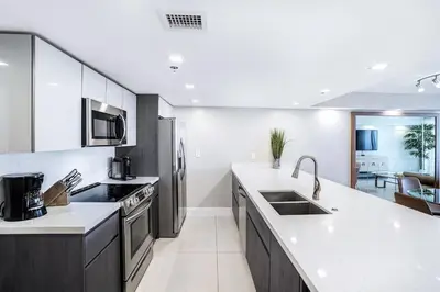 a kitchen with white counters and stainless steel appliances at Sunset Hideaway! Direct Water Views and Renovated! in Miami