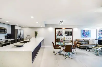 a kitchen and living room with a couch and a table at Sunset Hideaway! Direct Water Views and Renovated! in Miami