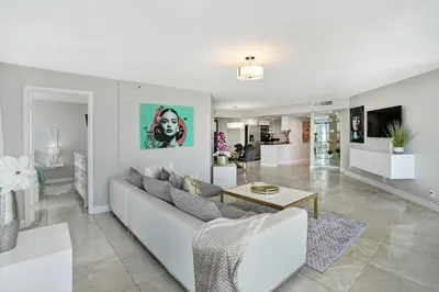 a living room with a couch and a table at Pisces Dream - Direct water views! in Miami