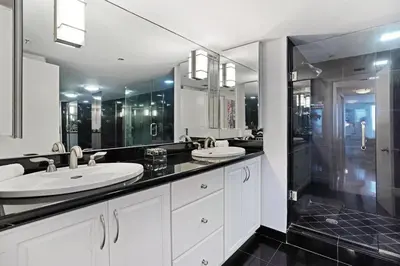 a bathroom with two sinks and a large mirror at Pisces Dream - Direct water views! in Miami