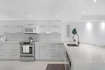 a white kitchen with a sink and a stove at Obsession! Water & Park Views in Miami