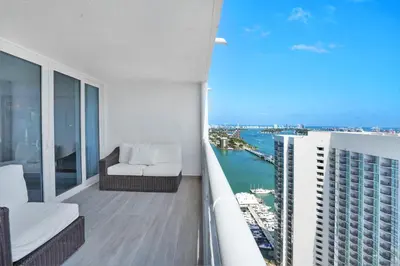 an apartment balcony with a view of the ocean at Classic Beauty! Skyline and water views in Miami