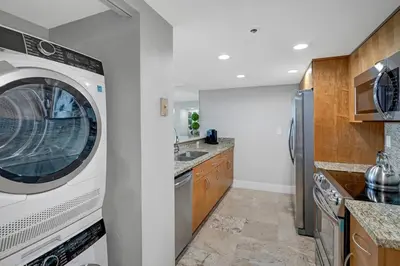 a kitchen with a washer and dryer at The Audrey! Penthouse With Direct Water Views! in Miami