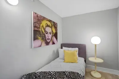 a bedroom with a bed and a painting on the wall at The Audrey! Penthouse With Direct Water Views! in Miami