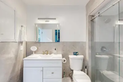 a bathroom with a sink and a toilet and a shower at Sunny Oasis in Hollywood
