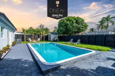 a swimming pool in the backyard of a home at Trendy Family Home -Heated Pool in Hollywood