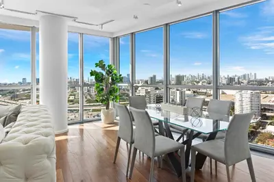 a dining room with a table and chairs and large windows at THE SETAI 5 STARS HOTEL-RESIDENCE MIAMI BEACH OCEANVIEW 2 Bedroom UNIQUE in Miami Beach