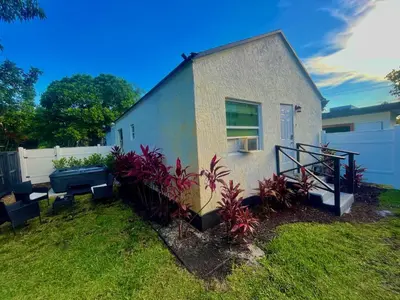 a house with plants in front of it at Bahama Mama Las Olas and Holiday Park w Hot Tub in Fort Lauderdale