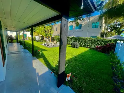 a patio with a grass yard with a building at Bahama Mama Las Olas and Holiday Park w Hot Tub in Fort Lauderdale